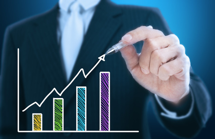 businessman writing rising graph ,blue background